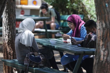 Students sit together under the shade of trees at the American University of Beirut. AFP