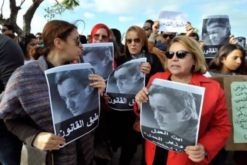 Tunisian demonstrators hold pictures of Sami Fehri, jailed boss of the Ettounsiya TV channel, during a protest calling for his release outside the presidencial palace in Carthage near Tunis last month.