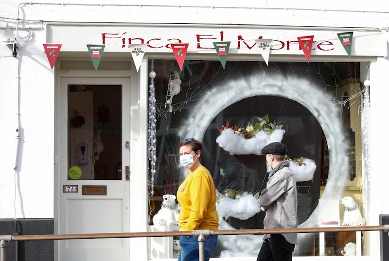 People walk past a shop that still has it's Christmas decorations on display, in Buckingham. Reuters
