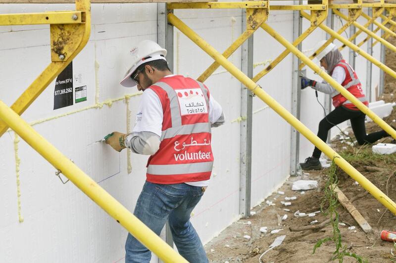 From left, Abed Al Blooshi and Iman Ustadi, take part in the Habitat for Humanity project in Sea Bright, New Jersey.