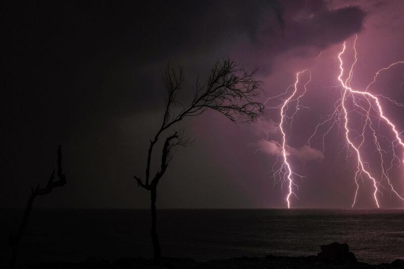 TOPSHOT - Lightning strikes off the coast of the mediterranean city of Batroun in northern Lebanon, on November 25, 2020.   / AFP / Ibrahim CHALHOUB
