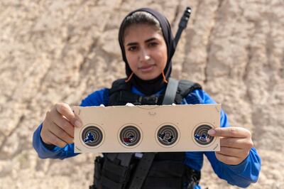 Team Sniper Lt Latifa Al Salman shows her shooting target practice results. Antonie Robertson / The National


