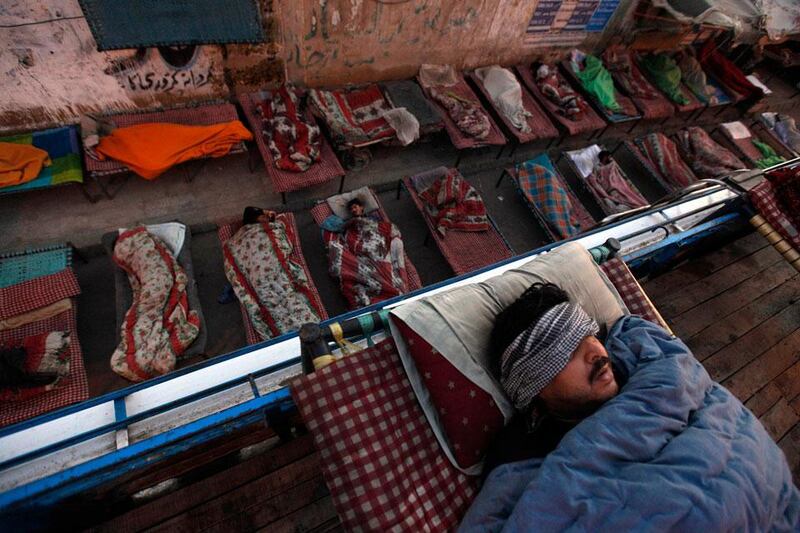 Sleeping carriage: people sleep on charpoy beds on a road near a railway station in Karachi, Pakistan. Akhtar Soomro / Reuters