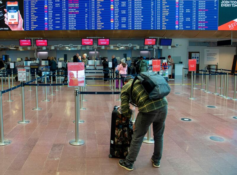 A raveller is ready to check in at Arlanda international airport outside Stockholm, where the airport is unusually empty due to concerns over the coronavirus, on March 12, 2020.   - Sweden OUT
 / AFP / TT NEWS AGENCY / Fredrik SANDBERG
