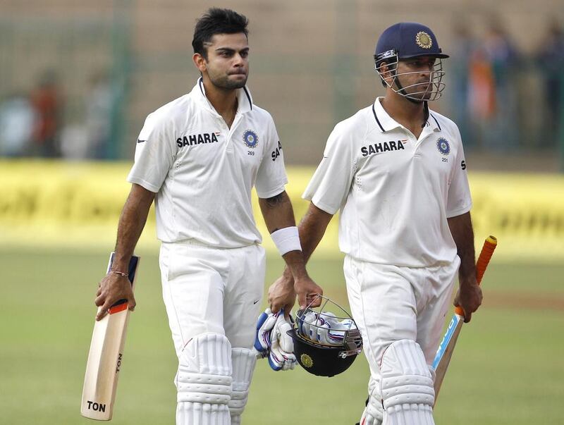 Virat Kohli will captain his first Test match for India starting on Tuesday with MS Dhoni, right, unable to play against Australia. Aijaz Rahi / AP