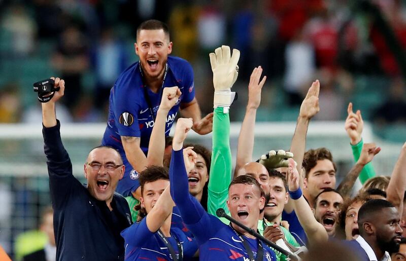 Hazard, top, celebrates with his teammates and manager Maurizio Sarri, left. Reuters