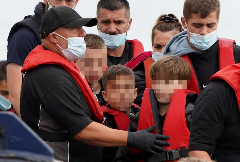 A group of people thought to be migrants are brought in to Dover, Kent, aboard a Border Force vessel. PA