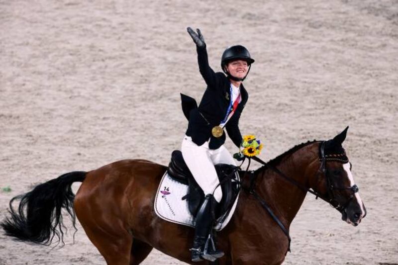 Gold medallist Germany's Julia Krajewski celebrates after competing in the equestrian's eventing individual jumping final.