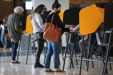 Voters mark their ballots at a Vote Center located at the Staples Center on the first weekend of early in-person voting on October 25, 2020 in Los Angeles, California. AFP