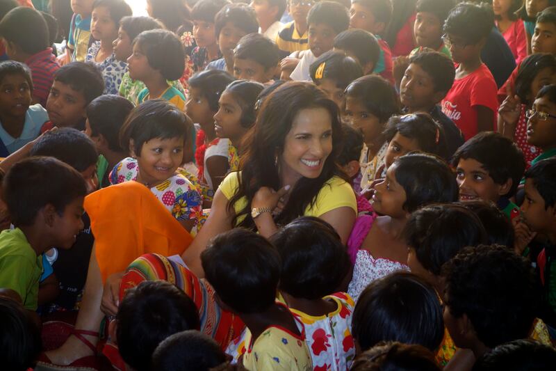 The 'Top Chef' host is greeted by pupils.