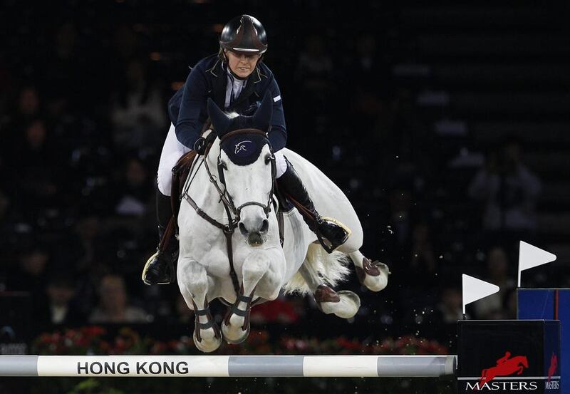 Katharina Offel of Ukraine, riding Charlie, clears a hurdle in the 1.6-metre jumping event of the Longines Hong Kong  Masters on February 23, 2014. Tyrone Siu / Reuters