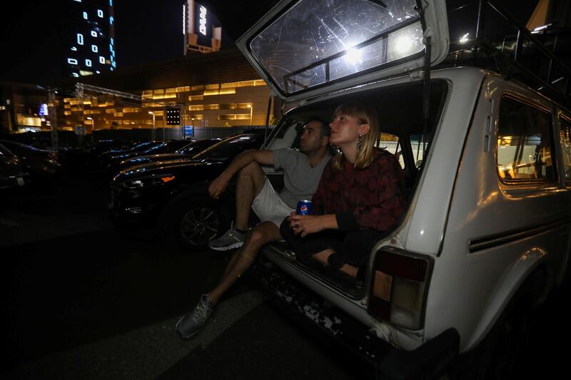 People sit in their cars during the official opening of Amman International Film Festival in the first drive-in cinema in Amman, Jordan. Reuters