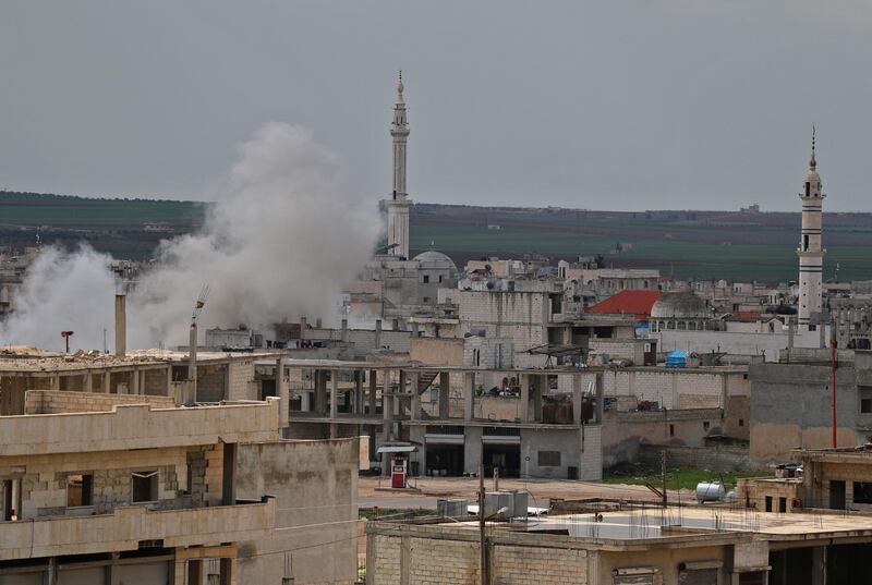 Smoke rises from buildings during reported shelling on the town of Khan Sheikhun in the southern countryside of the rebel-held Idlib province, on February 27, 2019.  / AFP / OMAR HAJ KADOUR
