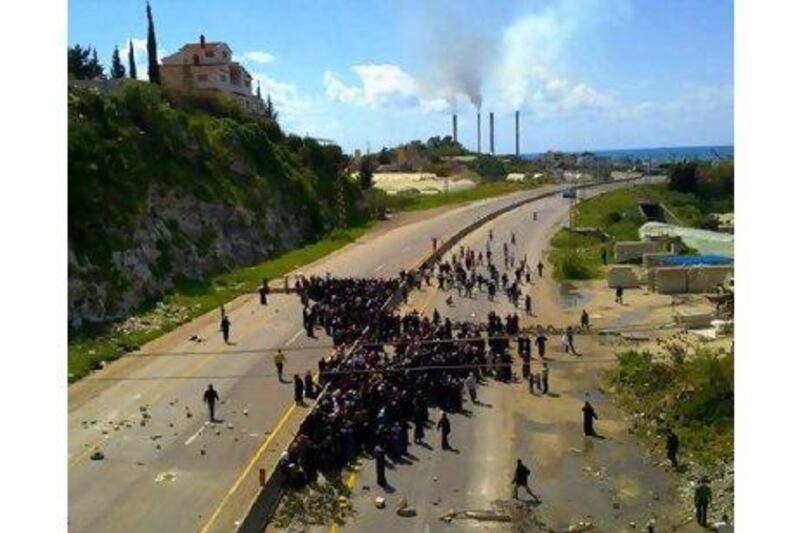 A picture made available to AFP and taken by a mobile phone shows thousands of Syrian women staging a sit-in on a main highway linking the towns of Tartus and Banias in Syria Wednesday to demand the release of men arrested after recent demonstrations.