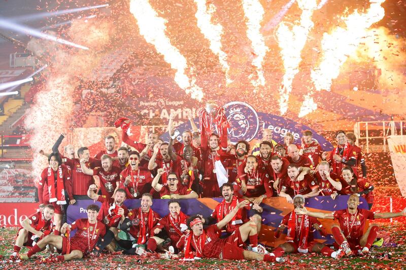 Liverpool players celebrate with the Premier League trophy. PA