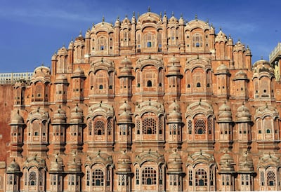 The facade of the Hawa Mahal or "Palace of Winds" in the old walled city of Jaipur on November 14, 2011.  The iconic building was designed to allow veiled ladies of the time to see the street scenes below without being seen. The baroque style building was built in 1799 by the Rajasthany royalty.  Jaipur is know as the "Pink City" because its prominent buildings are washed in hue of pink.           AFP PHOTO/Roberto Schmidt (Photo by ROBERTO SCHMIDT / AFP)