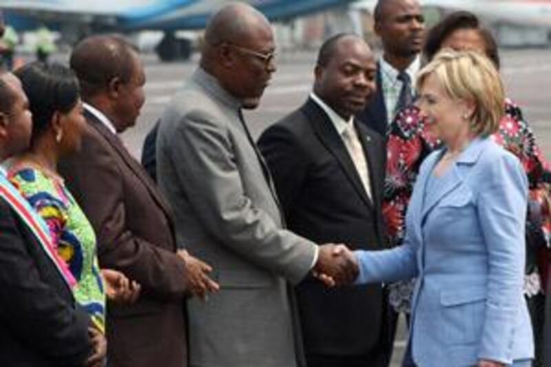 Members of the Congolese government greeet the US Secretary of State Hillary Clinton as she arrives in Kinshasa, Democratic Republic of Congo on Monday.