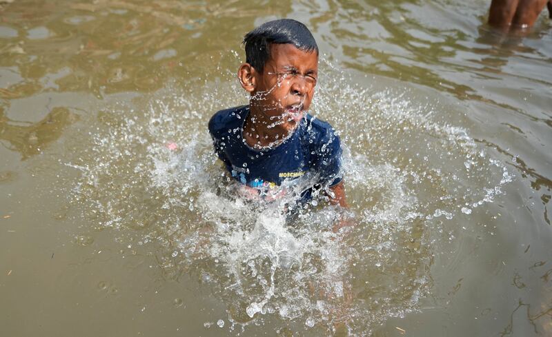 A boy bathes in the Ranbir Canal in Jammu. AP