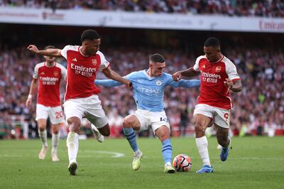 Phil Foden of Manchester City holds off from William Saliba and Gabriel Jesus of Arsenal during Sunday's 1-0 defeat at Emirates Stadium. Getty
