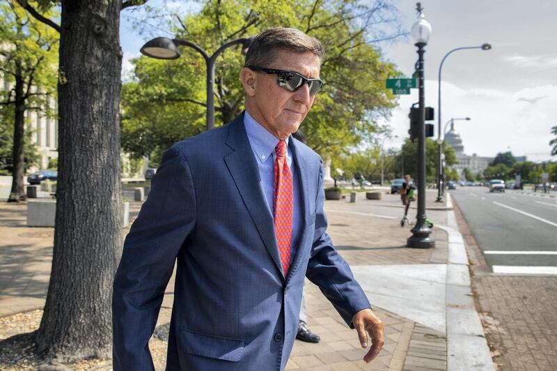 FILE - In this Sept. 10, 2019 file photo, Michael Flynn, President Donald Trump's former national security adviser, leaves the federal court following a status conference in Washington. The arrest of President Donald Trump‚Äôs former chief strategist Steve Bannon adds to a growing list of Trump associates ensnared in legal trouble. They include the president's former campaign chair, Paul Manafort, whom Bannon replaced, his longtime lawyer, Michael Cohen, and his former national security adviser, Michael Flynn.  (AP Photo/Manuel Balce Ceneta, File)