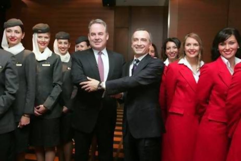 James Hogan, the chief executive of Etihad Airways, left, with John Borghetti, his counterpart at Virgin Blue Holdings, announce the partnership between the two companies in 2010. Sergio Dionisio / Bloomberg News