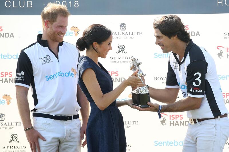 Nacho Figuares of Sentebale St. Regis presents the Sentebale Polo 2018 trophy with Meghan Duchess of Sussex and Prince Harry Duke of Sussex Getty Images