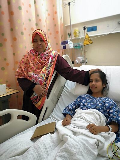 Komal recovers at Al Qasimi Hospital with her mother Arifa  by her side. Salam Al Amir / The National