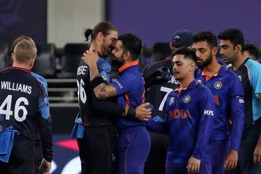 India's captain Virat Kohli hugs Namibia's David Wiese as he leads team members out into the field after winning the Cricket Twenty20 World Cup match between India and Namibia in Dubai, UAE, Monday, Nov.  8, 2021.  (AP Photo / Aijaz Rahi)