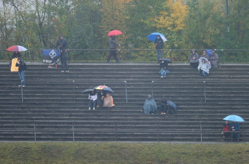 Fans endure the rain at the Nurburgring racetrack. AP