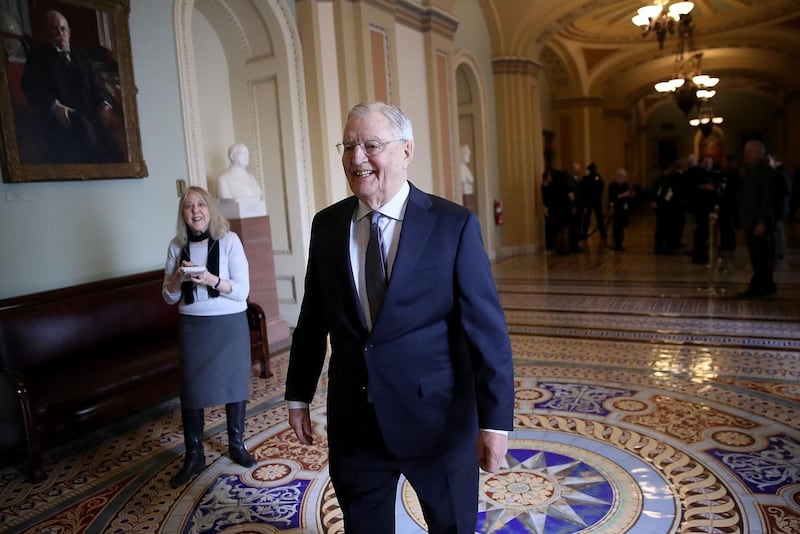 Mondale walks outside the US Senate chamber in the Capitol. AFP/Getty Images
