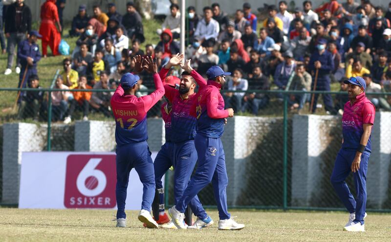 Rohan Mustafa of UAE celebrates a wicket with Vriitya Aravind.