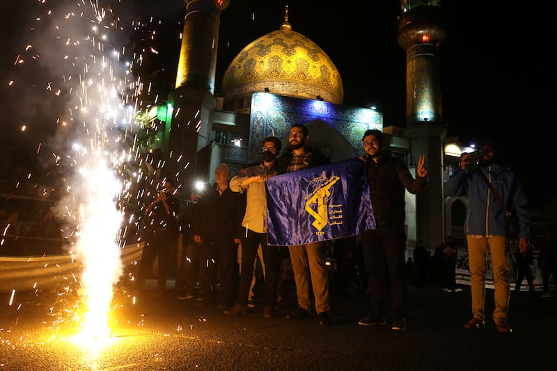 Iranians appear to celebrate in the street after the attack. Wana (West Asia News Agency) / Reuters 