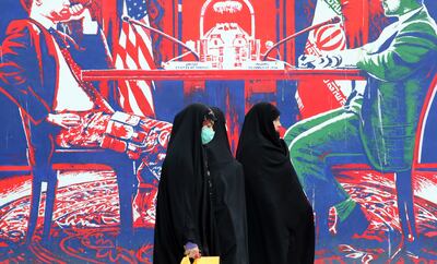 Iranian women walk past an anti-US wall painting last week. Tensions between Iran and the US over 2015 nuclear deal persist. EPA