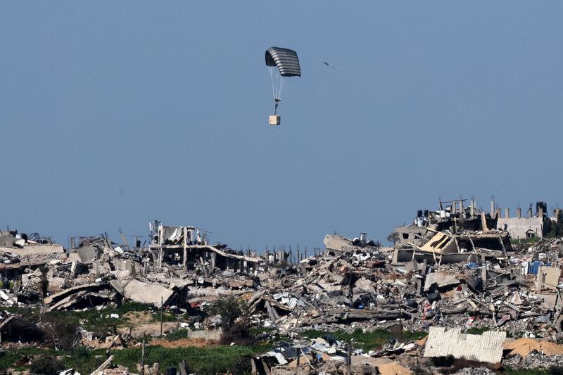 The Israeli military drops a box over destroyed buildings in the Gaza Strip. AFP