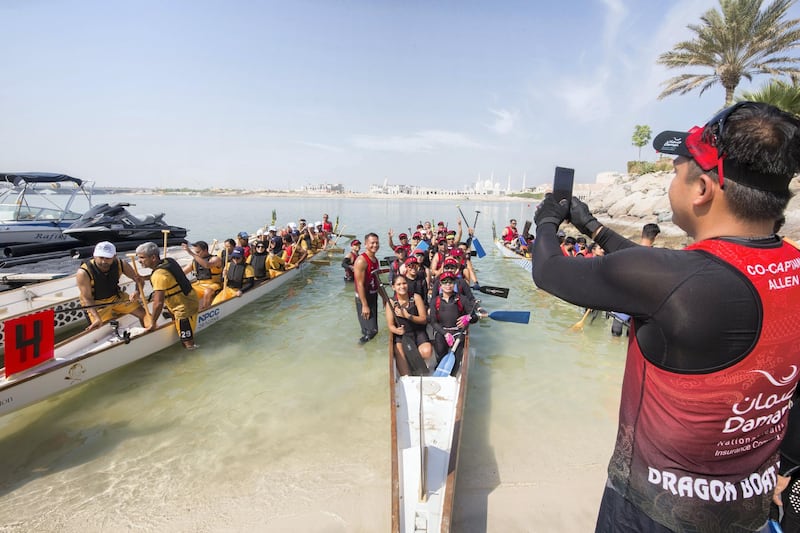 Abu Dhabi, United Arab Emirates - Team taking group shot before the race at the Dragon Boat Festival Abu Dhabi.  Leslie Pableo for The National