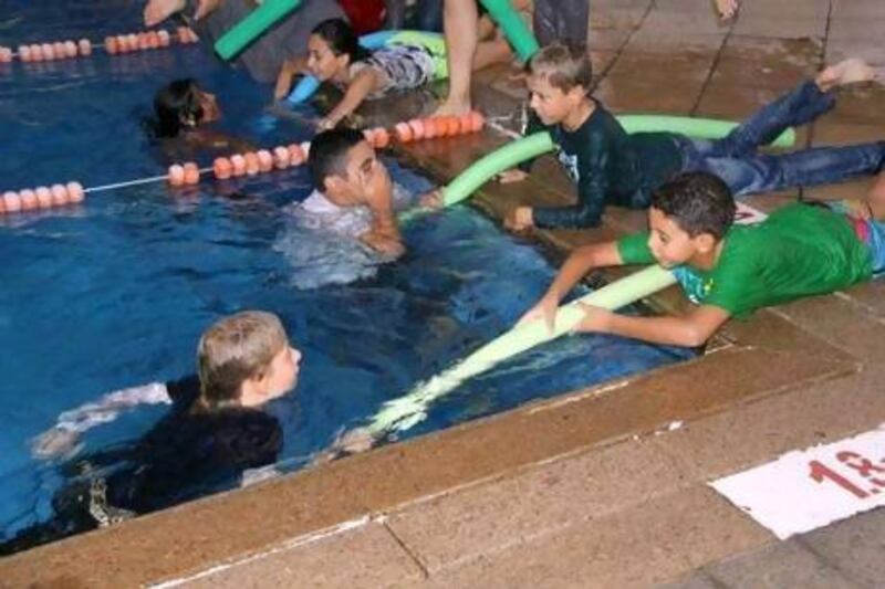 Children take part in AISS swimming and water safety lessons in Hayya Health Clubs in Emirate Hills, Dubai.