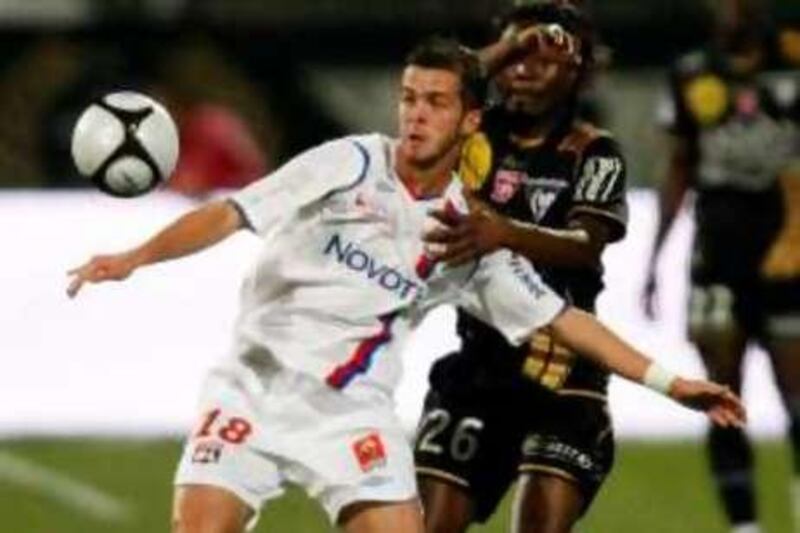 Olympique Lyon's Miralem Pjanic (L) challenges Joel Nguemo of Nancy during their French League 1 soccer match at the Gerland stadium in Lyon September 27, 2008.    REUTERS/Robert Pratta (FRANCE) *** Local Caption ***  LYN11_SOCCER-_0927_11.JPG