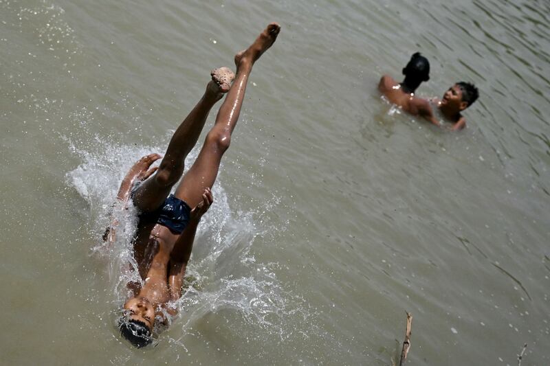 A boy dives into a lake to cool off in New Delhi. Increasing areas of concrete and shrinking green areas have increased urban heat, says Mahesh Palawat, of private forecaster Skymet Weather. AFP