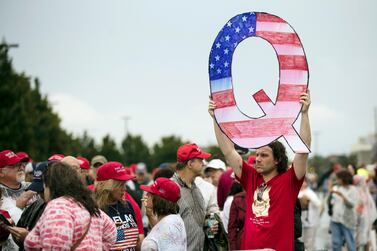 FILE - In this Aug.  2, 2018, file photo, a protester holds a Q sign as he waits in line with others to enter a campaign rally with President Donald Trump in Wilkes-Barre, Pa.  Casino giant Caesars Entertainment Inc.  said Wednesday, Sept.  1, 2021, that a conference scheduled next month in Las Vegas by a group espousing the fringe conspiracy theory known as QAnon won't be held at any Caesars property.  (AP Photo / Matt Rourke, File)