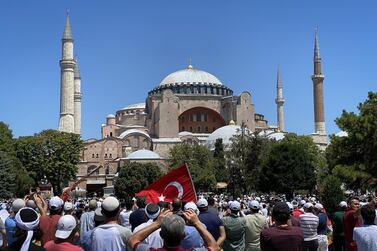 People gather outside during the opening ceremony to mark the first day of prayers at the Hagia Sophia mosque, in the Sultanahmet district of Istanbul, Turkey, on Friday, July 24, 2020. Turkey's President Recep Tayyip Erdogan is holding the first Islamic prayer at the iconic Hagia Sophia in nearly a century, a calculated move to boost the embattled Turkish president’s popularity at home and in the Muslim world. Photographer: Kerem Uzel/Bloomberg