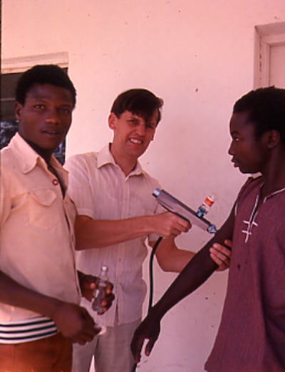 Prof Sir Brian Greenwood tests the Pedojet injector gun for vaccines in northern Nigeria in 1975. Photo: Prof Sir Brian Greenwood