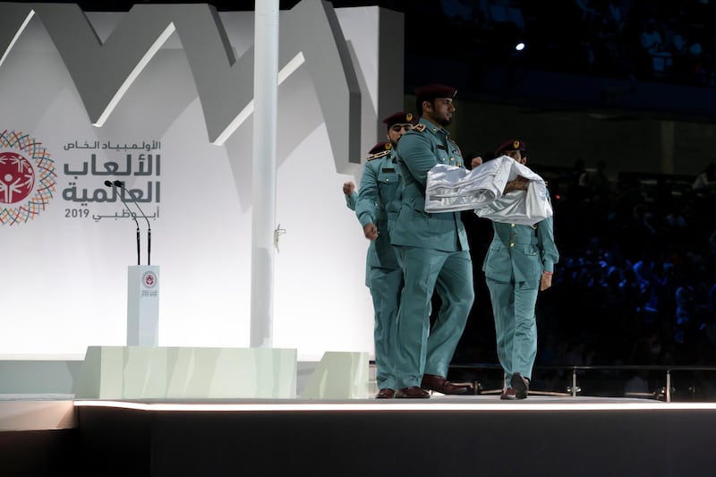 ABU DHABI, UNITED ARAB EMIRATES - March 21, 2019: Abu Dhabi Police presents the Special Olympics flag to the upcoming Special Olympics host during the closing ceremony of the Special Olympics World Games Abu Dhabi 2019, at Zayed Sports City. 
( Ryan Carter for the Ministry of Presidential Affairs )
---