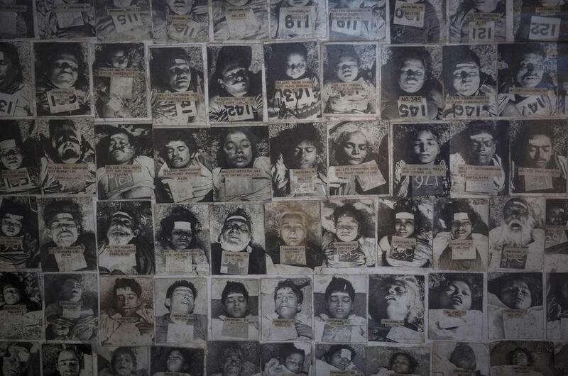 A panel displays pictures of residents who died in the 1984 Bhopal disaster at the forensic department of a hospital in Bhopal.
