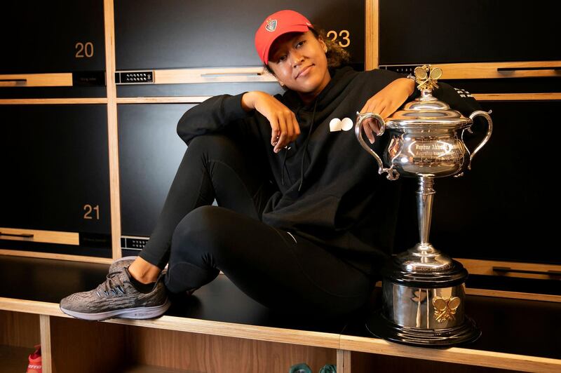 Naomi Osaka posing with the trophy after beating Jennifer Brady at the 2021 Australian Open. AFP