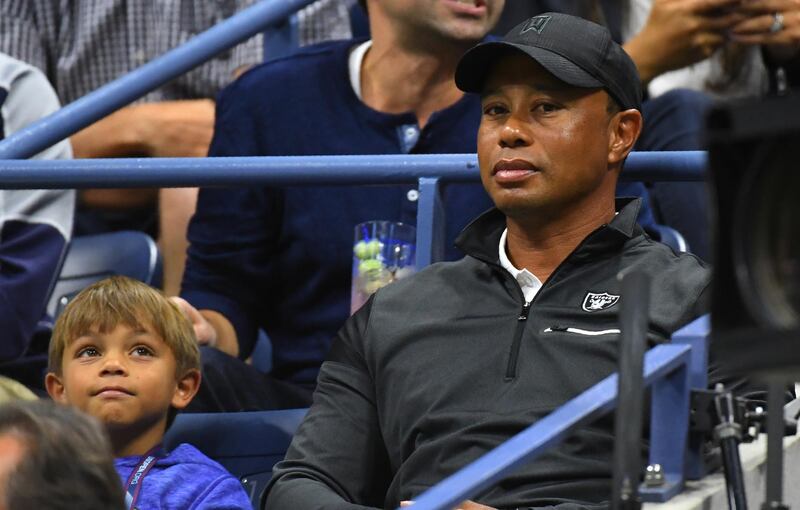 Tiger Woods and his son Charlie watch Rafael Nadal of Spain against Juan Martin del Potro of Argentina during their Men's semifinal singles match of the US Open 2017 at the USTA Billie Jean King National Tennis Center on September 8, 2017 in New York. (Photo by TIMOTHY A. CLARY / AFP)