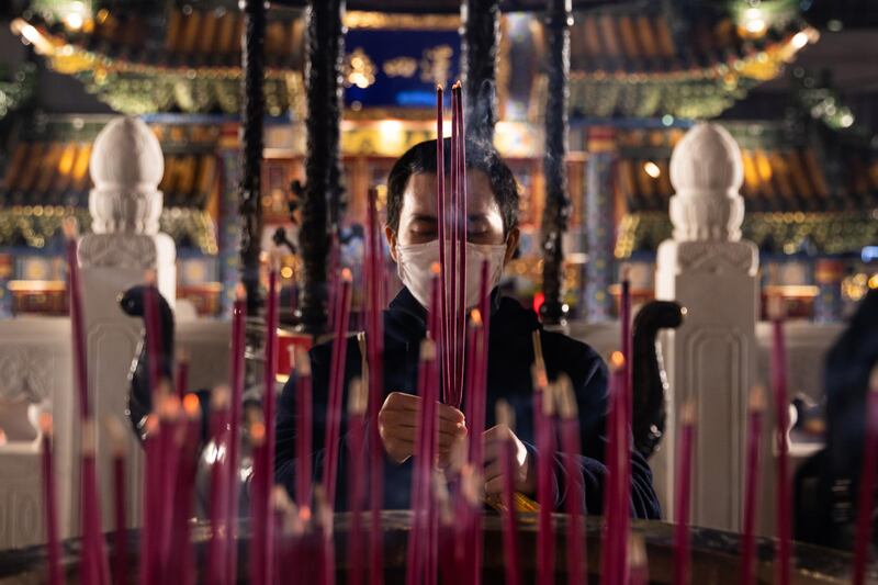 A man prays at Ma Zhu Miao Temple during subdued Lunar New Year celebrations in Yokohama, Japan. Getty Images