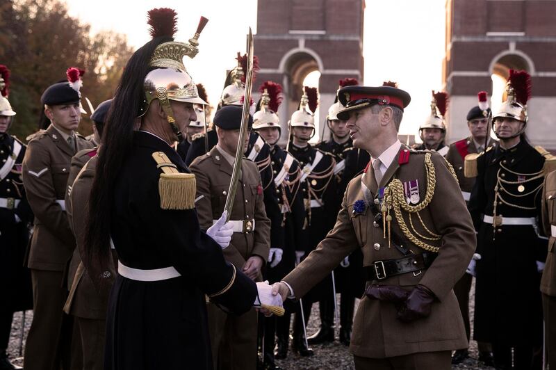 epa07153906 A British soldier of the Royal Fusiliers (R) and a French Republican guard check hands after a remembrance ceremony at the WWI Thiepval Commonwealth Memorial, in Thiepval, northern France, 09 November 2018. The memorial commemorates more than 72,000 men of British and South African forces who died in the Somme sector before 20 March 1918 and have no known grave, the majority of whom died during the Somme offensive of 1916. The 11 November 2018 marks the 100th anniversary of the First World War Armistice with services taking place across the world to commemorate the occasion.  EPA/ETIENNE LAURENT