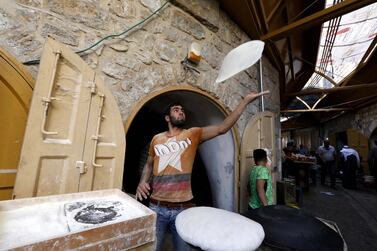 epa07589759 A Palestinian baker prepares 'Saj' bread a traditional pastry sold during Ramadan in the divided West Bank town of Hebron, 21 May 2019. Muslims around the world celebrate the holy month of Ramadan by praying during the night time and abstaining from eating, drinking, and sexual acts during the period between sunrise and sunset. Ramadan is the ninth month in the Islamic calendar and it is believed that the revelation of the first verse in Koran was during its last 10 nights. EPA/ABED AL HASHLAMOUN