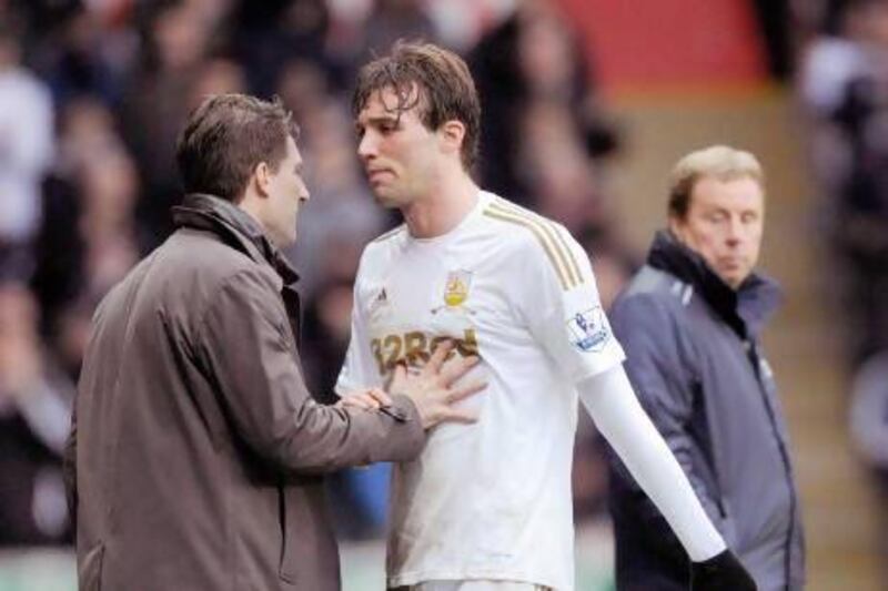 Swansea City's Michu, centre, and manager Michael Laudrup have both stated their intention to stay with the Welsh club.