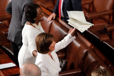 House Speaker Nancy Pelosi of Calif., holds the copy of President Donald Trump's State of the Union address she tore up after he delivered it to a joint session of Congress on Capitol Hill in Washington, Tuesday, Feb. 4, 2020. At left is Rep. Val Demings, D-Fla. (AP Photo/J. Scott Applewhite)